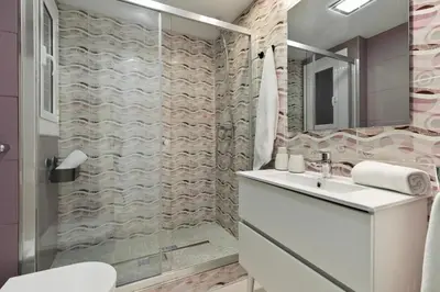 a bathroom with a shower with a sink and a toilet at Click&Flat Luxury Tetuan in Barcelona