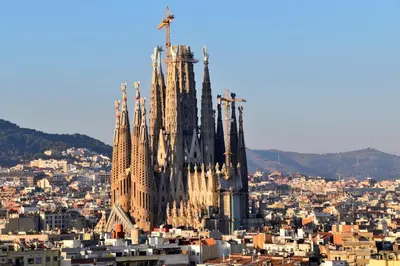 a large cathedral building with a city in the background at Click&Flat Luxury Tetuan in Barcelona
