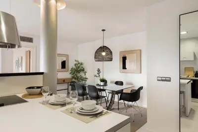 a kitchen and dining room with a table and chairs at Click&Flat Luxury Tetuan in Barcelona