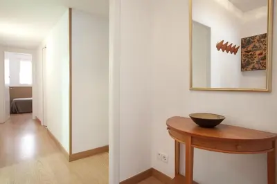 a hallway with a table and a mirror on a wall at Click&Flat Floridablanca in Barcelona