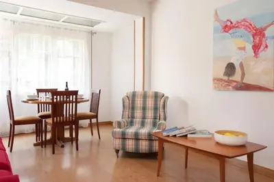 a living room with a table and a chair at Click&Flat Floridablanca in Barcelona