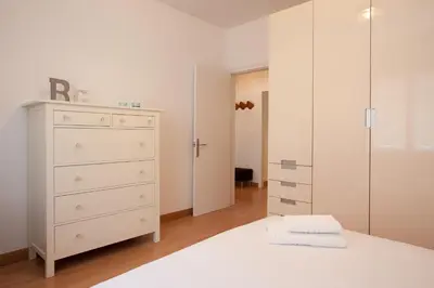a bedroom with a white bed and a dresser at Click&Flat Floridablanca in Barcelona
