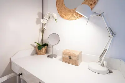 a white desk with a mirror and a lamp at Beach, Restaurants and Views in Castelldefels