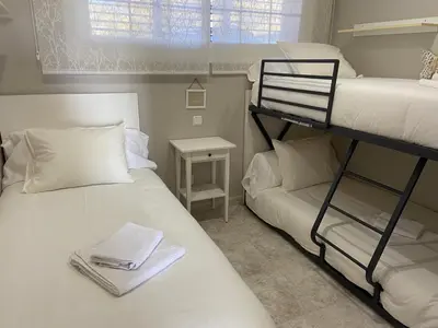 two bunk beds in a small room with a window at Karin Palma Fiesta-Vallpineda-Sitges in Sant Pere de Ribes