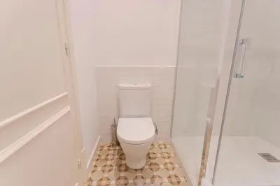 a bathroom with a toilet and a shower at Bcn Paseo De Gracia Rocamora Apartment in Barcelona