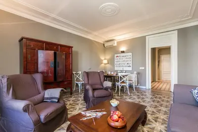 a living room with two couches and a table at Bcn Paseo De Gracia Rocamora Apartment in Barcelona