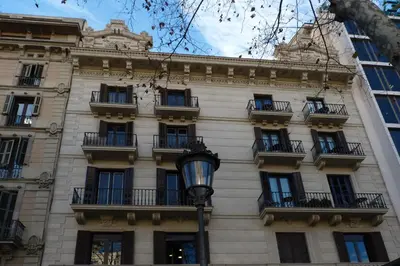 a building with balconies and a street light in front at Bcn Paseo De Gracia Rocamora Apartment in Barcelona