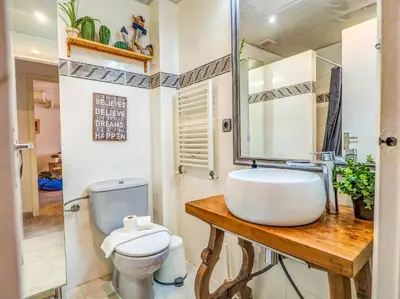 a bathroom with a sink and a toilet at The Beach Holi Apartment by Hello Homes Sitges in Sitges