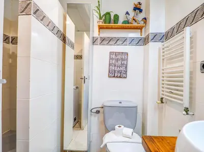 a bathroom with a toilet and a sink at The Beach Holi Apartment by Hello Homes Sitges in Sitges