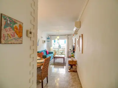 a hallway with a living room and a dining room at The Beach Holi Apartment by Hello Homes Sitges in Sitges