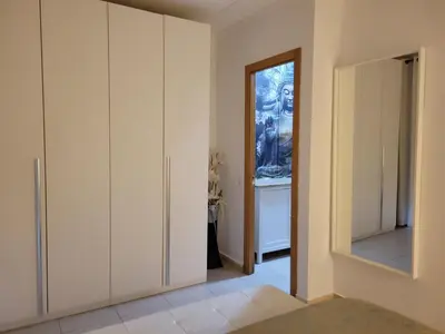 a hallway with white cabinets and a mirror at Trip Barcelona Spain in Barcelona