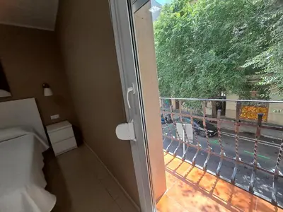 a bedroom with a balcony with a view of a street at Trip Barcelona Spain in Barcelona