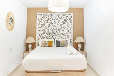 a bedroom with a large white bed with two lamps at HA Diputació terrace apartment in Barcelona