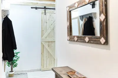 a mirror hanging on a wall next to a door at HA Diputació terrace apartment in Barcelona