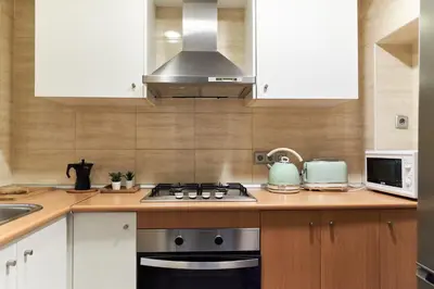 a kitchen with a stove and a microwave at HA Diputació terrace apartment in Barcelona