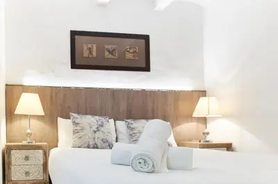 a hotel room with two beds and two lamps at HA Diputació terrace apartment in Barcelona