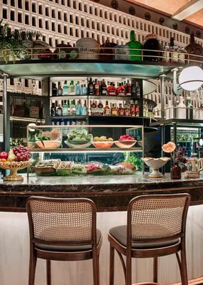 a restaurant with two chairs and a counter with food at Antiga Casa Buenavista in Barcelona