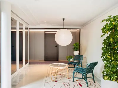a hallway with two chairs and a glass table at Antiga Casa Buenavista in Barcelona