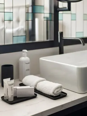 a bathroom counter with a sink and a towel at Antiga Casa Buenavista in Barcelona