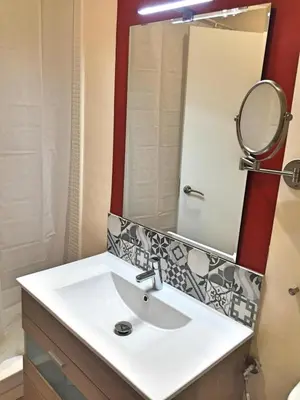 a bathroom with a sink and a mirror at Guest House Barcelona Bruc in Barcelona