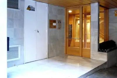 a building with a revolving door in a building at Guest House Barcelona Bruc in Barcelona