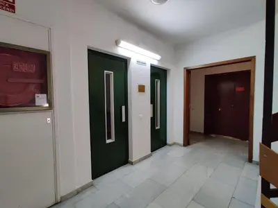 a hallway with three green doors in a building at Guest House Barcelona Bruc in Barcelona