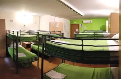 a group of bunk beds in a room with green walls at Guest House Barcelona Bruc in Barcelona