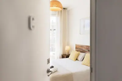 a bedroom with a bed and a window at Sunny and modern apartment ideal for groups in Barcelona