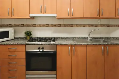 a kitchen with a stove and a sink at Sunny and modern apartment ideal for groups in Barcelona