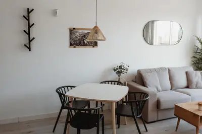 a living room with a couch and a table and chairs at Apartamentos Espai Progres by Be Barcelona in Hospitalet de Llobregat