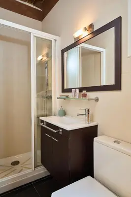 a bathroom with a sink and a mirror and a toilet at Casa Cosi - El Farro 3 in Barcelona