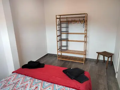 a room with a red bed and a shelf at Apartamentos Turísticos Tenor by Bossh! Hotels in Barcelona