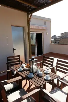 a wooden table and chairs on a patio at Apartamentos Turísticos Tenor by Bossh! Hotels in Barcelona