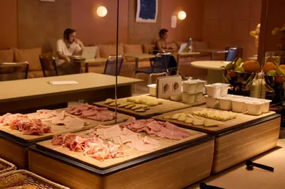 a buffet line with different types of food on display at Latroupe Poblenou Beach in Barcelona