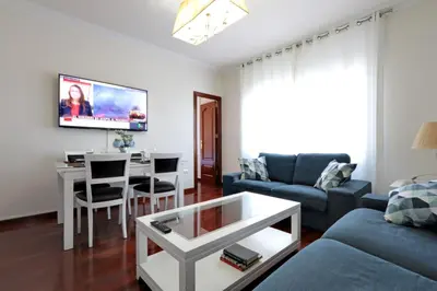 a living room with a couch and a table at Classbedroom Fira Business Apartment in Barcelona