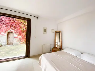 a bedroom with a bed and a window at Medieval tower & villa by the sea in Caldes d'Estrac