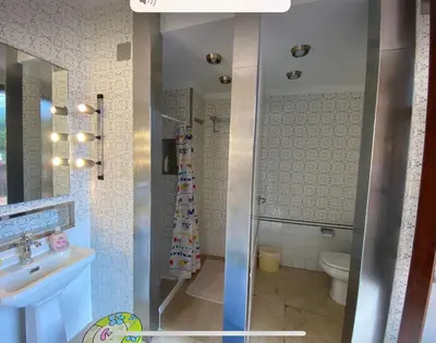a bathroom with a shower and a sink and a toilet at Medieval tower & villa by the sea in Caldes d'Estrac