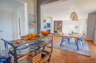 a living room with a table and a dining room at Villa Elysian by Hello Homes Sitges in Sant Pere de Ribes