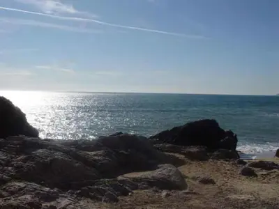 a beach with some rocks and the ocean at Casa de Pueblo junto Barcelona Centro in Vilassar de Dalt