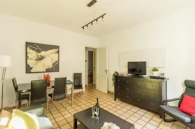 a living room with a couch and a dining room at rentBCN City Center Apartment in Barcelona