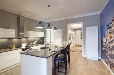 a kitchen with a large island in a room at Apartments Barcelona & Home Deco Centro in Barcelona