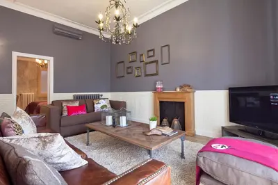 a living room with a couch and a tv at Apartments Barcelona & Home Deco Centro in Barcelona