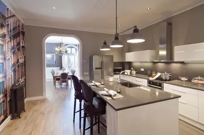 a kitchen with a island with chairs and a table at Apartments Barcelona & Home Deco Centro in Barcelona