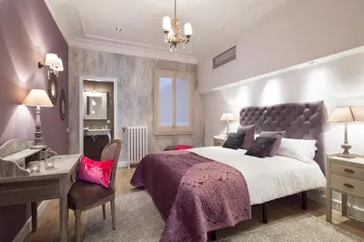 a bedroom with a large bed and a desk at Apartments Barcelona & Home Deco Centro in Barcelona