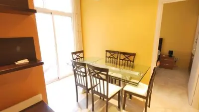a dining room with a glass table and chairs at Homenfun Barcelona Paralelo in Barcelona