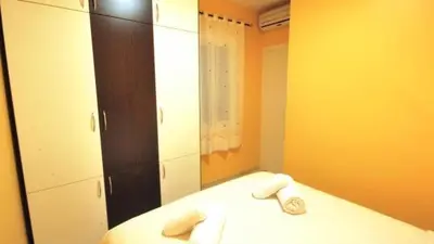 a bedroom with a bed with towels and a mirror at Homenfun Barcelona Paralelo in Barcelona