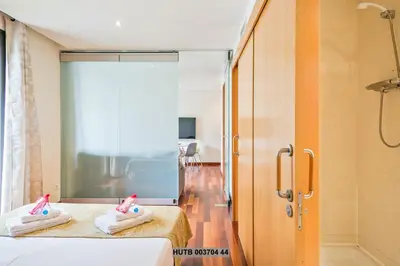 a bathroom with two towels on a bed and a shower at Alcam Anglesola in Barcelona