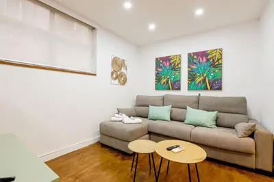 a living room with a couch and a table at Alcam Torrent in Barcelona