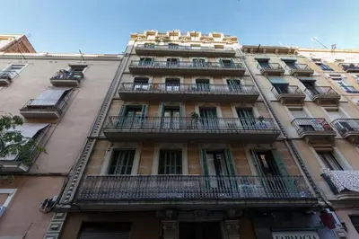 a tall building with balconies on the side of it at Alcam Molino in Barcelona