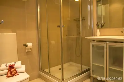 a shower with a glass door in a bathroom at Alcam Molino in Barcelona